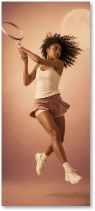 A woman leaping mid-air, tennis racket raised
